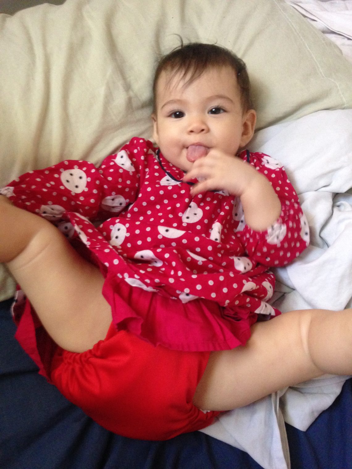 cute baby with red dress and matching cloth diaper