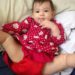 cute baby with red dress and matching cloth diaper